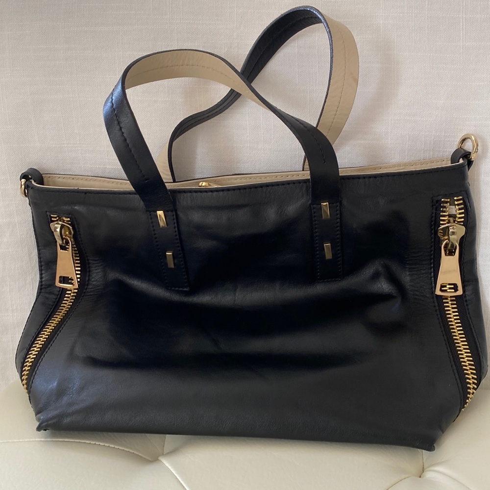 Genuine leather. Made in Italy. Gold side zippers.